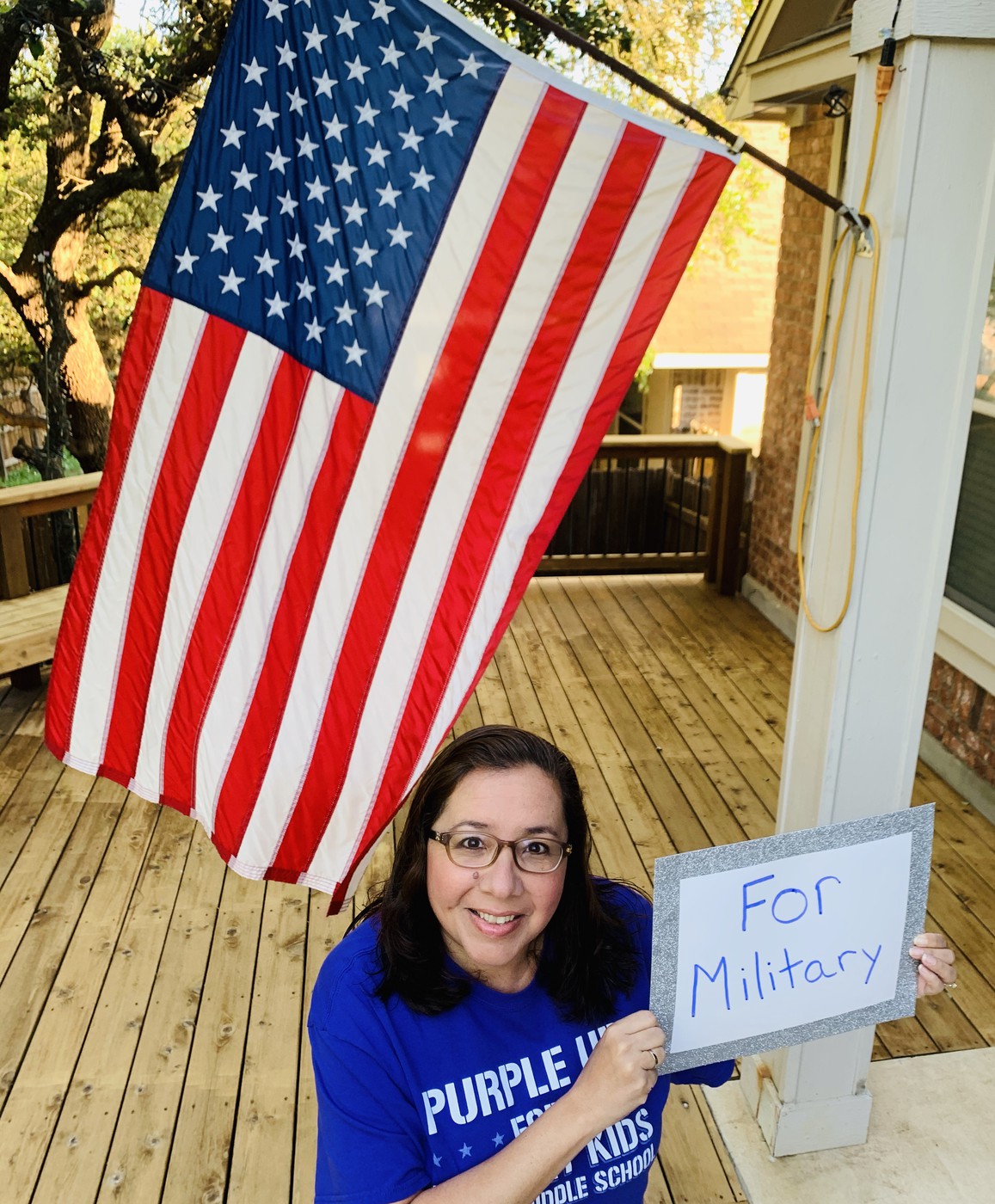 SALLY MAHER Holding sign that reads "For Military"