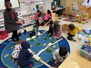 Students building a racecar track.