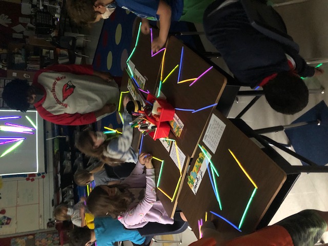 Students building with light sticks.
