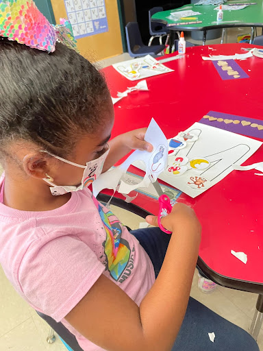 Student cutting out pictures