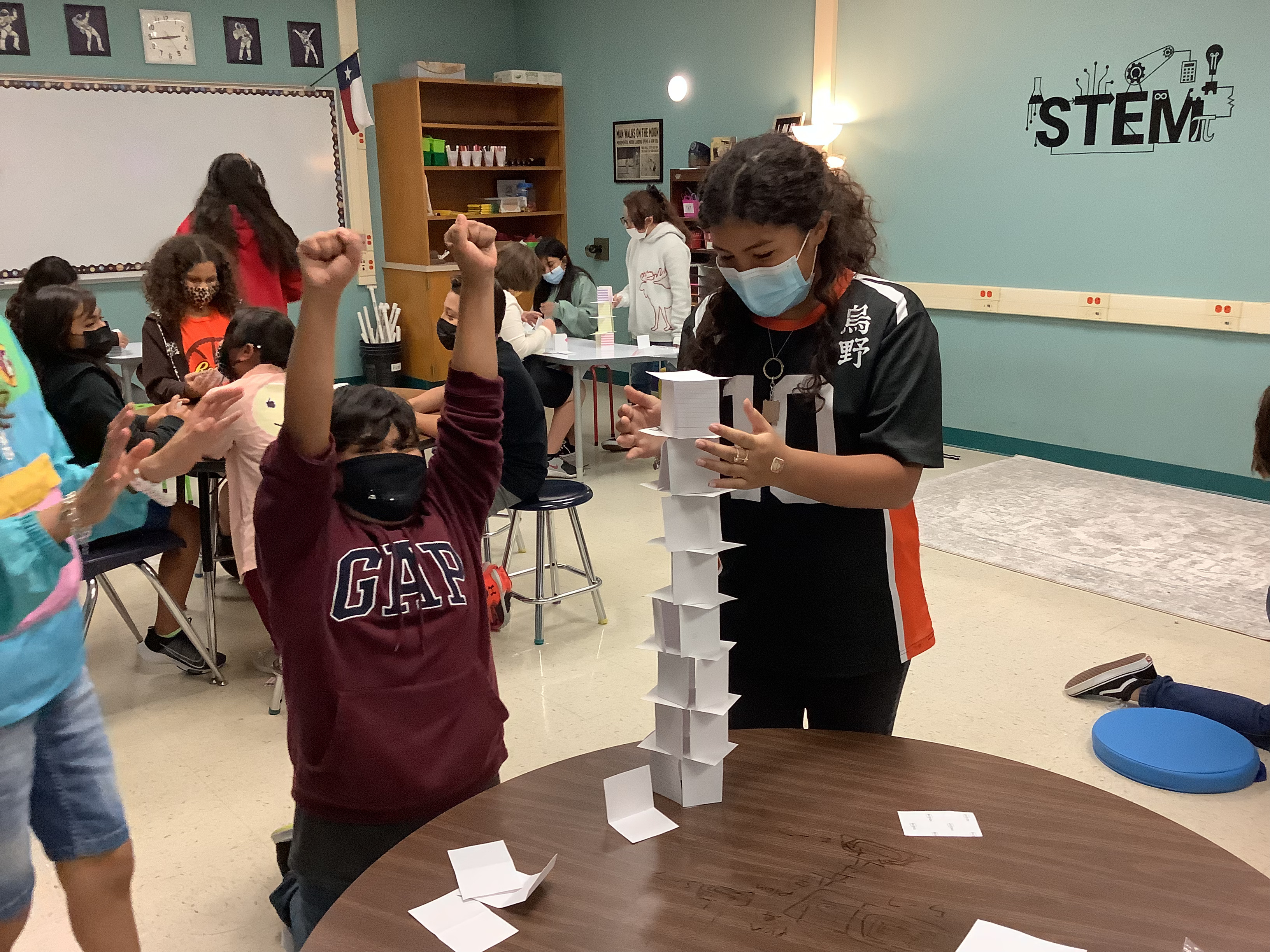 Two students rejoice after completing a STEM project.