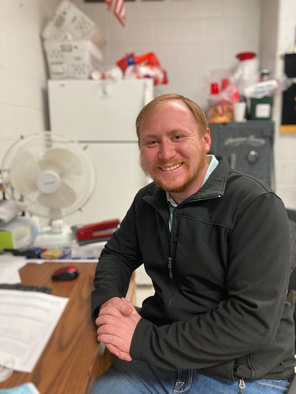 Mr. Pouncy sitting by his desk