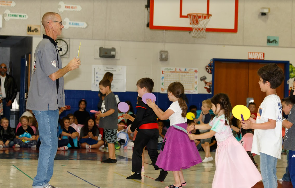 Pic of Coach leading student in sock hop dance
