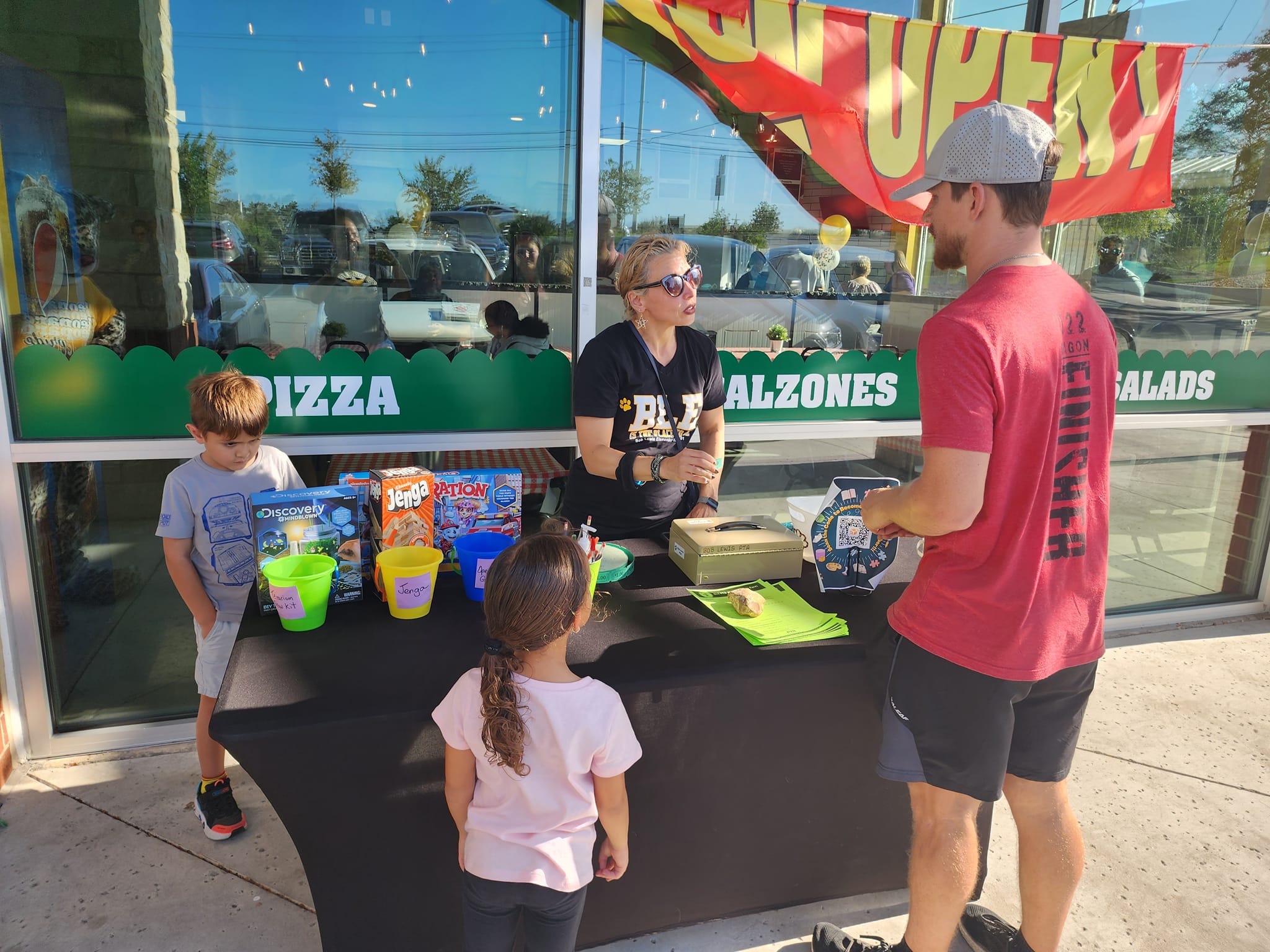 A PTA member signing parents up for a raffle.