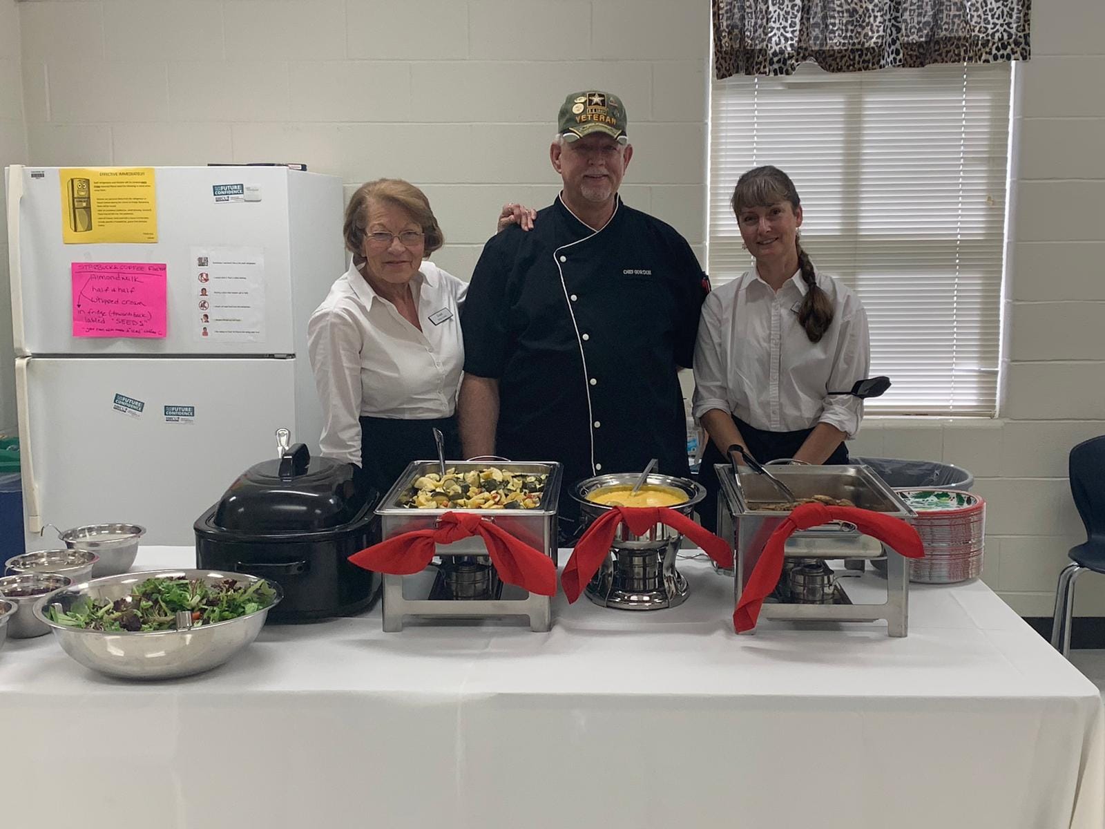 One male and two female chefs preparing the food for staff.