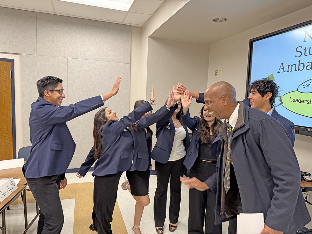Ambassadors giving high fives
