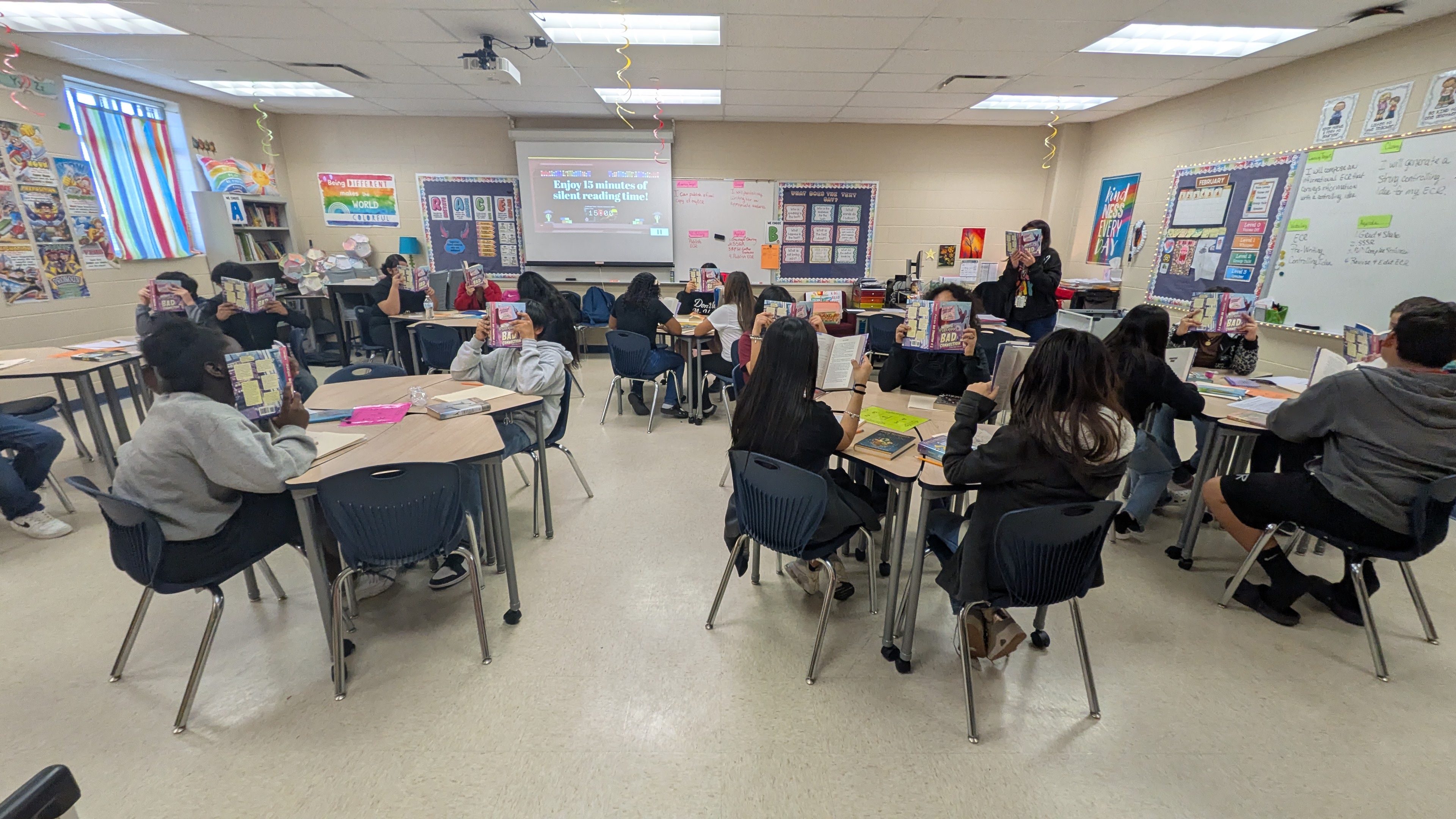 students hold books they were gifted for a giveaway
