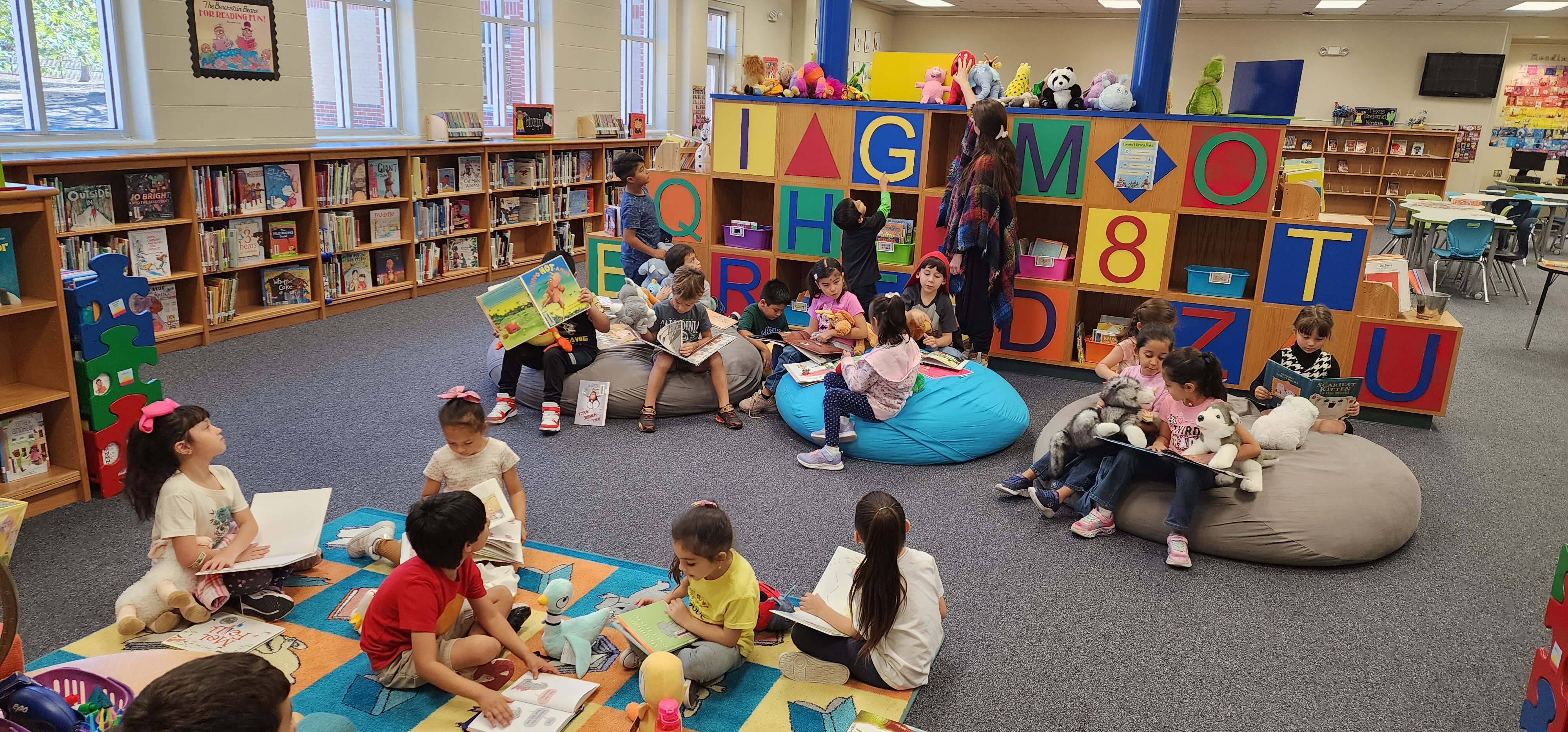 Langley Lobos reading on bean bags with Reading Buddies in the Langley Library.