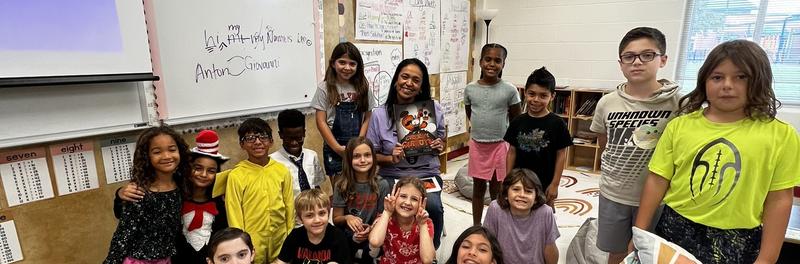 Principle Kilpatrick reading to a group of students in class