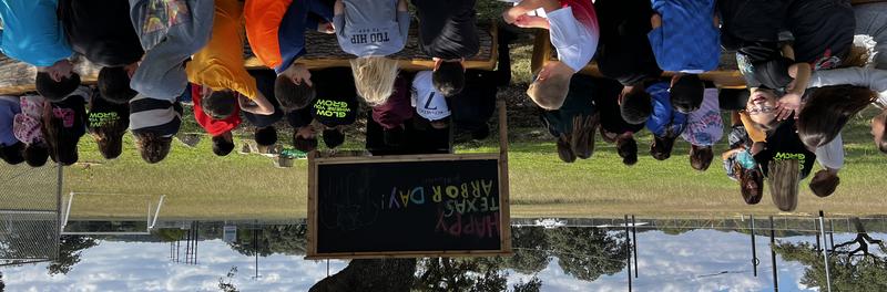 students sitting in the outdoor classroom on a nice sunny day