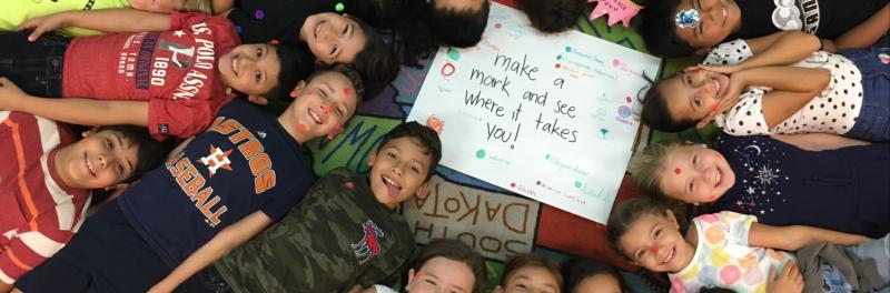 students gathered around smiling