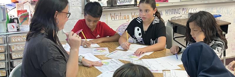McDermott students working in a small group with their teacher, Mrs Hall