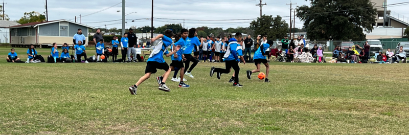 McDermott students playing soccer on a field