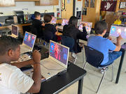 Students on their laptops in class