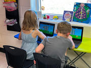 elementary school students on their classroom devices
