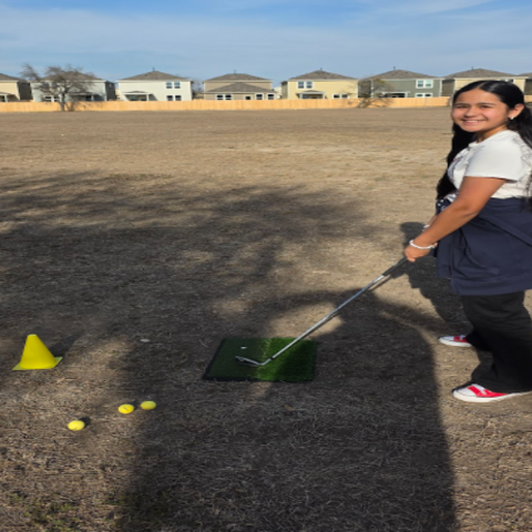 Student next to golf tee