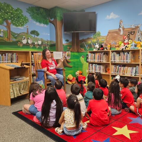 Mrs. Romero reading to a class