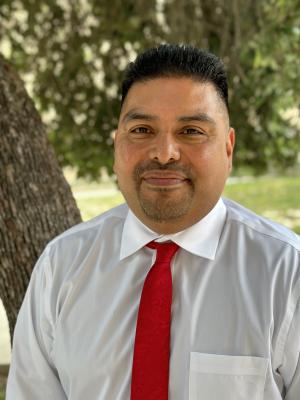 Picture of Principal Aurelio Hernandez outdoors in front of tree