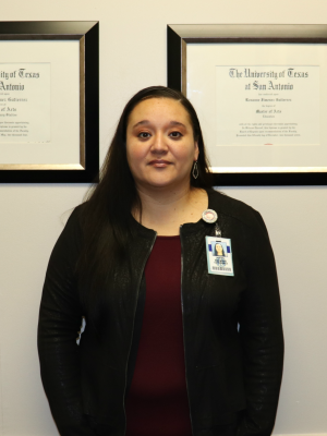 Villarreal's Principal Roxanne Gutierrez in front of her degrees.