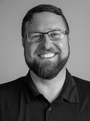 Black and white head shot of Principal, Ryan Purtell