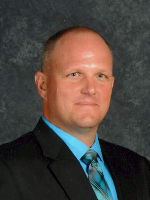 Shawn McKenzie, Principal of Folks Middle School, wearing a suit
